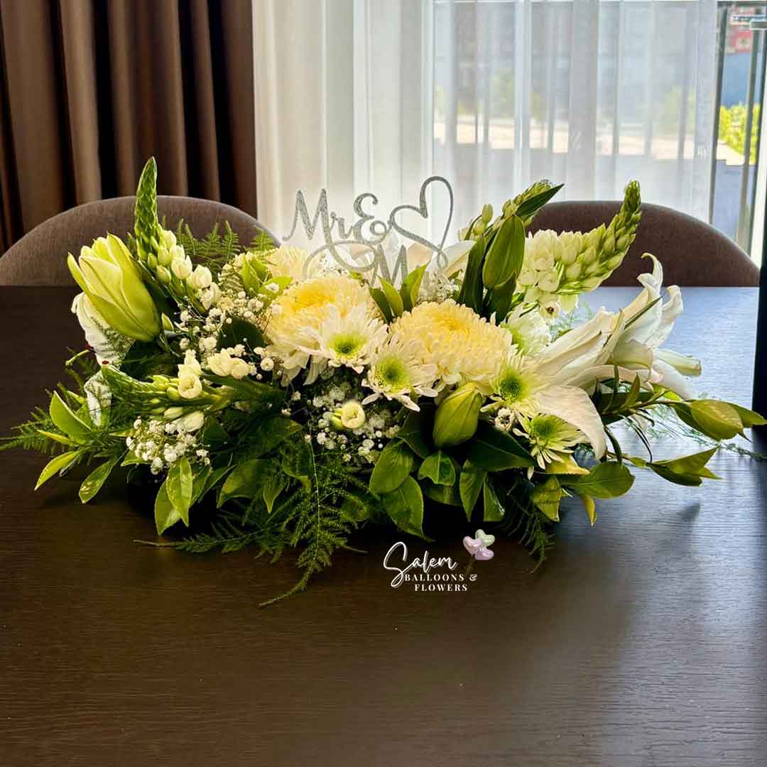 our Pure Serenity White flower arrangement, featuring white lilies, moms and dragon flowers and personalized with a Mr & Mrs sign. Salem Oregon Flower delivery.